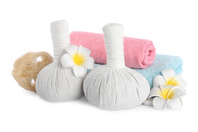 Photo of Herbal massage bags, towels, flowers and loofah on white background. Spa procedure