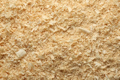 Photo of Dry natural sawdust as background, top view