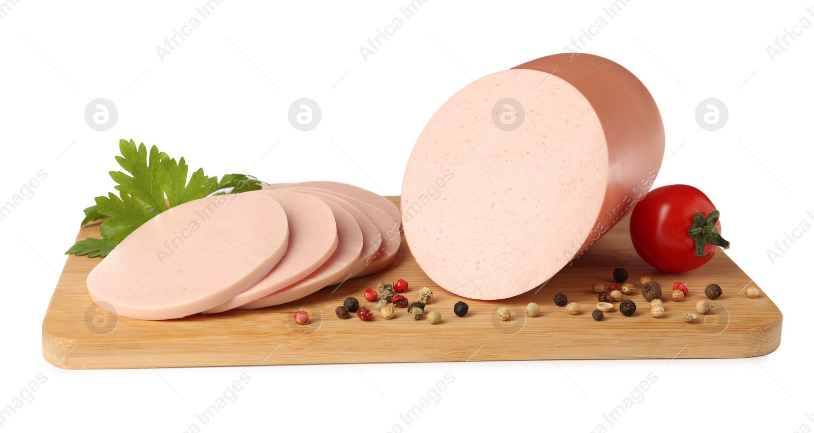 Photo of Wooden board with delicious boiled sausage, tomato, parsley and peppercorns isolated on white