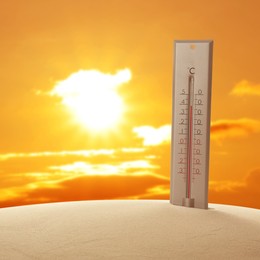 Image of Weather thermometer with high temperature outdoors on hot sunny day. Heat stroke warning