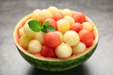 Photo of Melon and watermelon balls with mint served on grey table