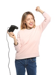 Emotional young woman playing video games with controller isolated on white