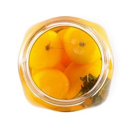 Photo of Open jar with pickled yellow tomatoes on white background, top view