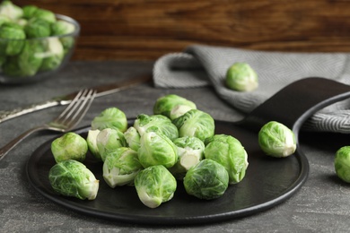 Fresh Brussels sprouts on grey table, closeup