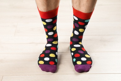 Photo of Man in stylish socks on floor, closeup