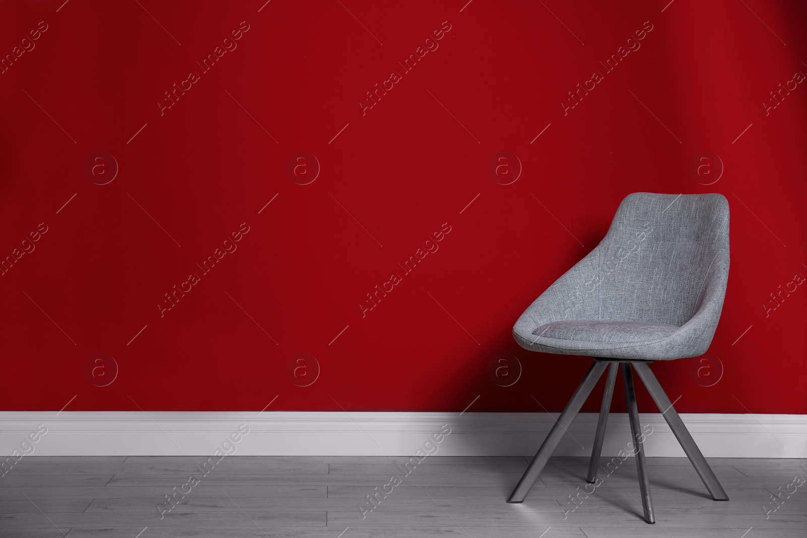 Photo of Grey modern chair for interior design on wooden floor at red wall
