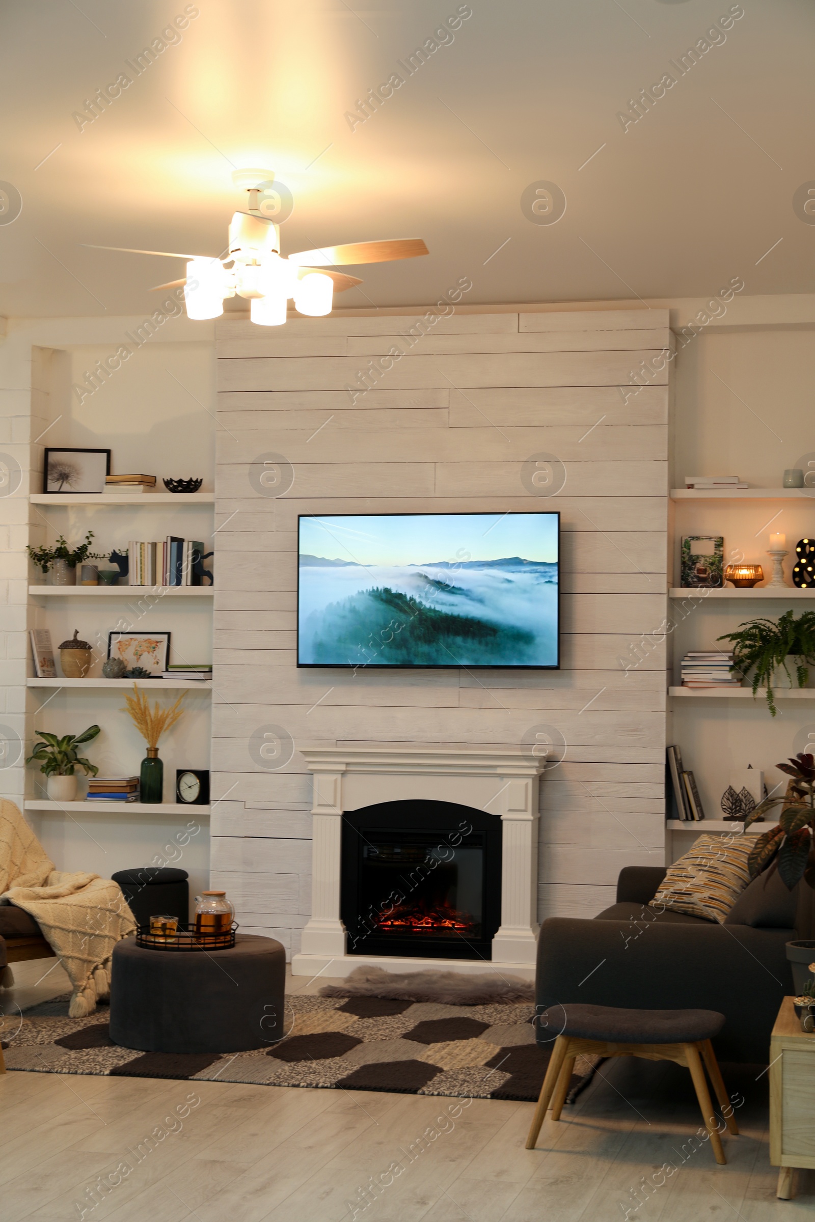 Photo of Cozy living room interior with comfortable sofa and decorative fireplace