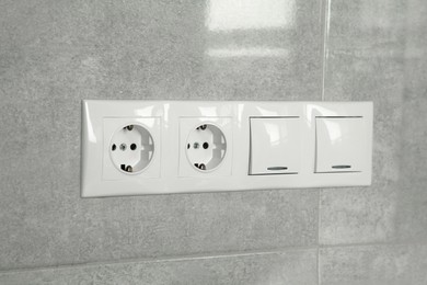 Light switches and power sockets on wall indoors