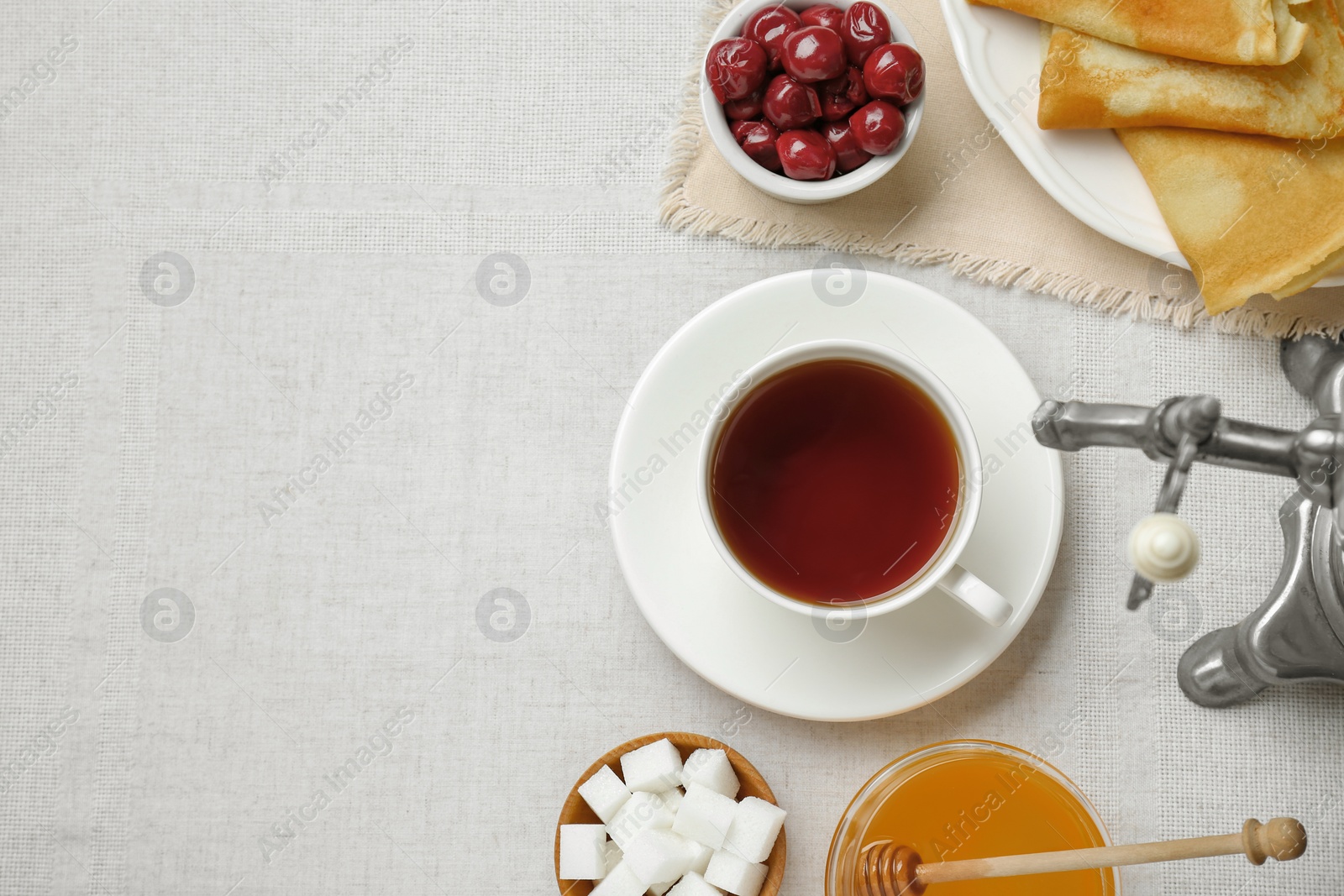 Photo of Cup of aromatic tea and treats on table, flat lay. Space for text