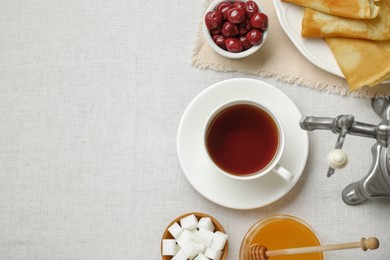 Photo of Cup of aromatic tea and treats on table, flat lay. Space for text