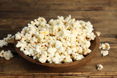 Photo of Tasty fresh pop corn on wooden table