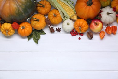 Photo of Happy Thanksgiving day. Flat lay composition with pumpkins on white wooden table, space for text