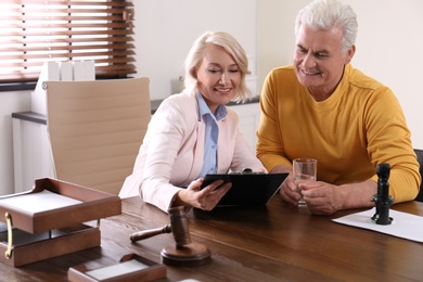 Photo of Female notary working with client in office