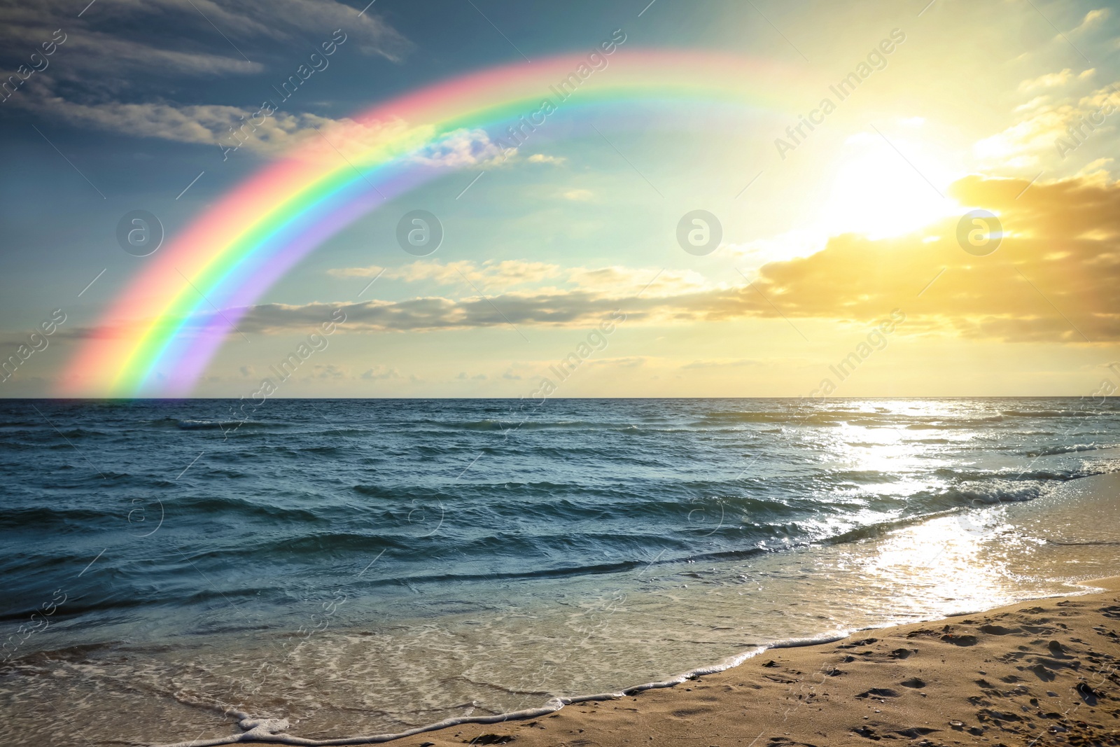 Image of Beautiful view of colorful rainbow in sky over sea