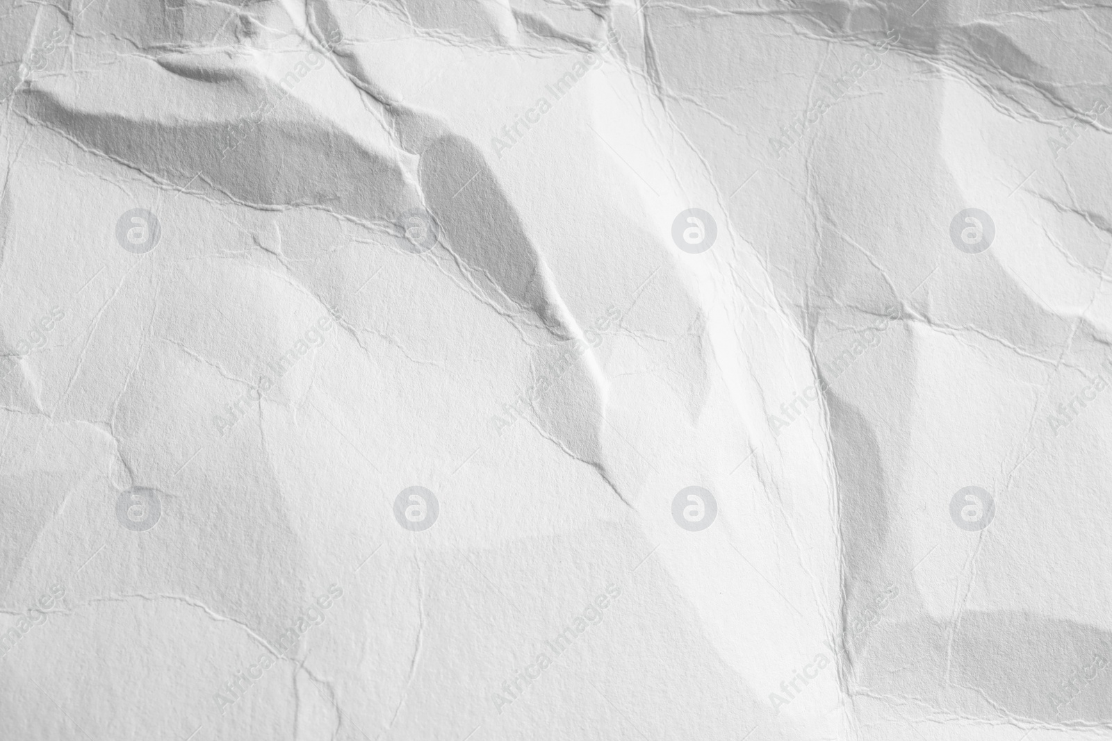 Photo of Crumpled white paper sheet as background, closeup