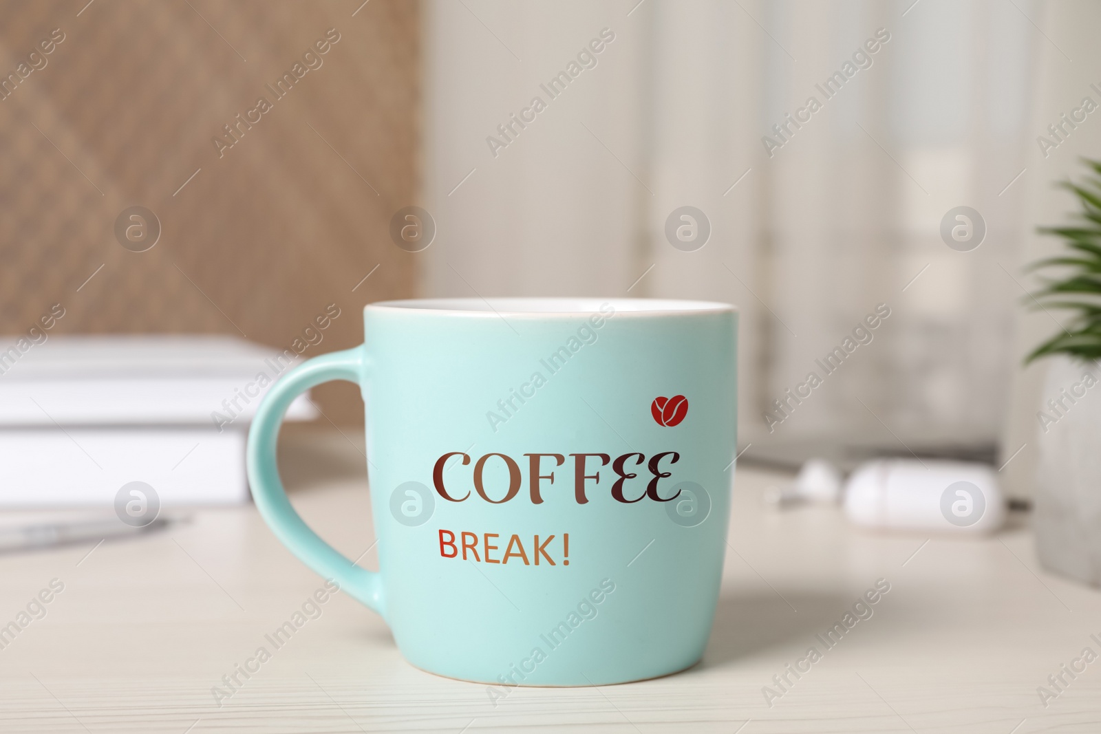 Image of Mug with inscription Coffee Break on white wooden table in office