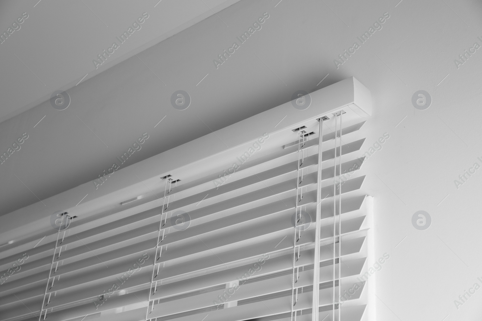 Photo of Window with closed blinds in room, low angle view