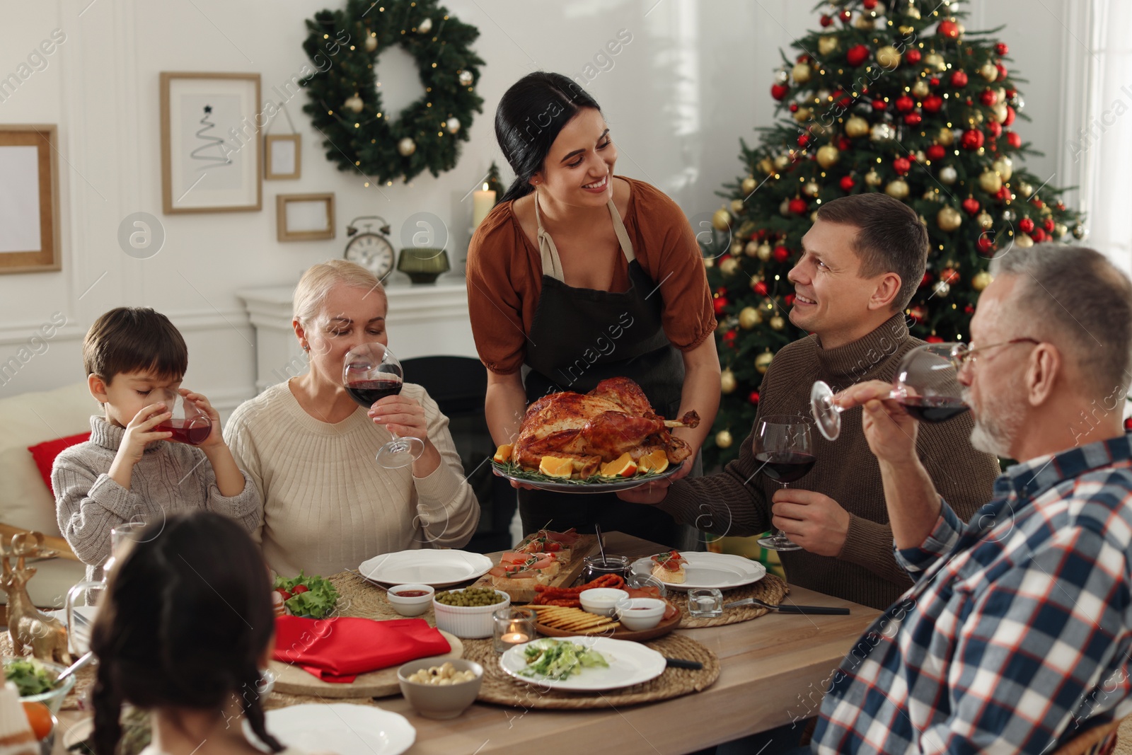 Photo of Happy family enjoying festive dinner at home. Christmas celebration