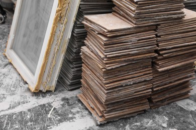 Photo of Stacks of ceramic tiles and window on grey floor