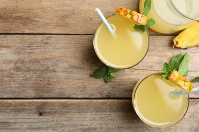 Photo of Delicious fresh pineapple juice with mint on wooden table, flat lay. Space for text