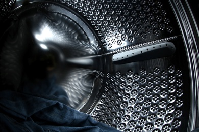 Photo of Empty washing machine drum, closeup view. Laundry day