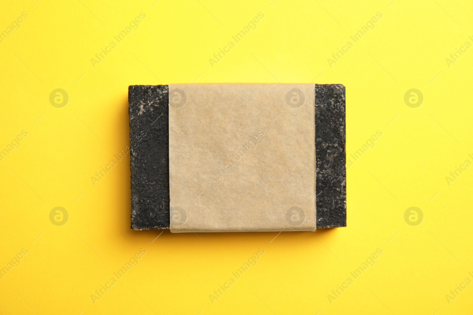 Photo of Hand made soap bar in package on color background, top view. Mockup for design