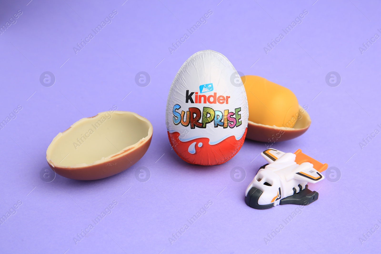 Photo of Sveti Vlas, Bulgaria - June 30, 2023: Kinder Surprise Eggs, plastic capsule and toy on violet background