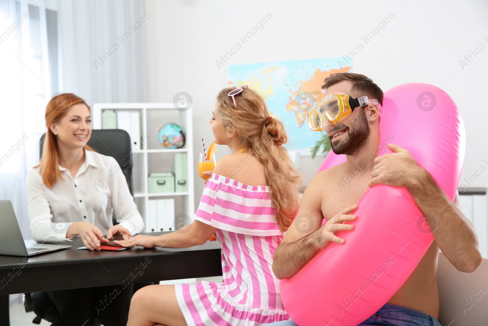 Photo of Beautiful young couple visiting travel agency office