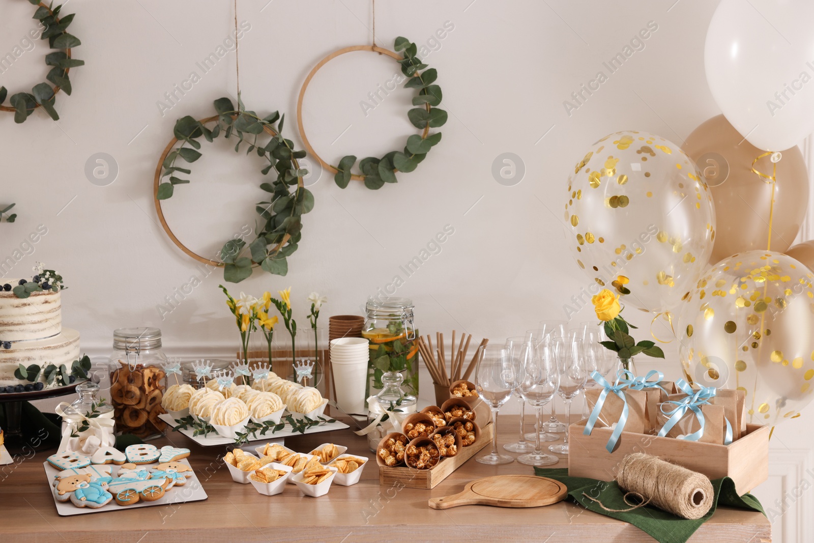 Photo of Beautiful cake and other treats on table in room. Baby shower party