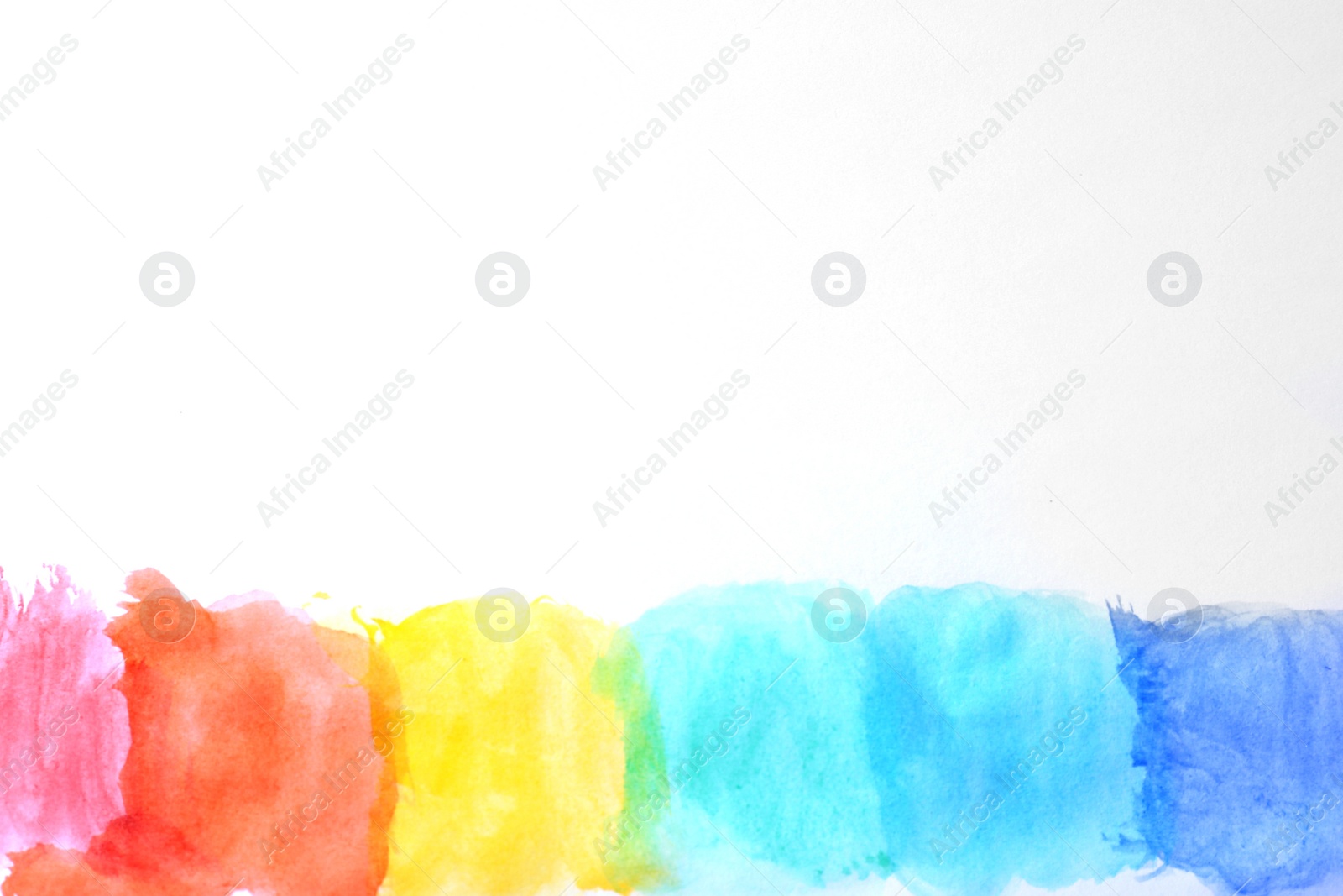 Photo of Rainbow drawing with watercolor paint on white paper, top view