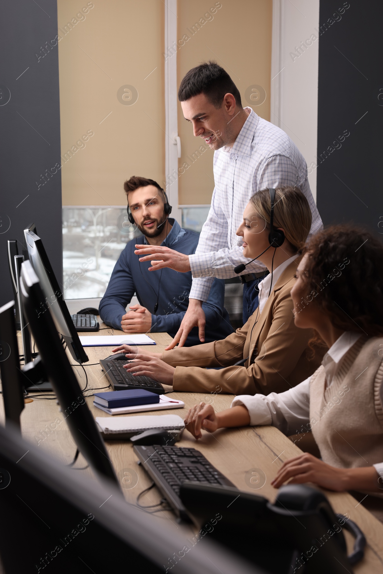 Photo of Call center operators working in modern office