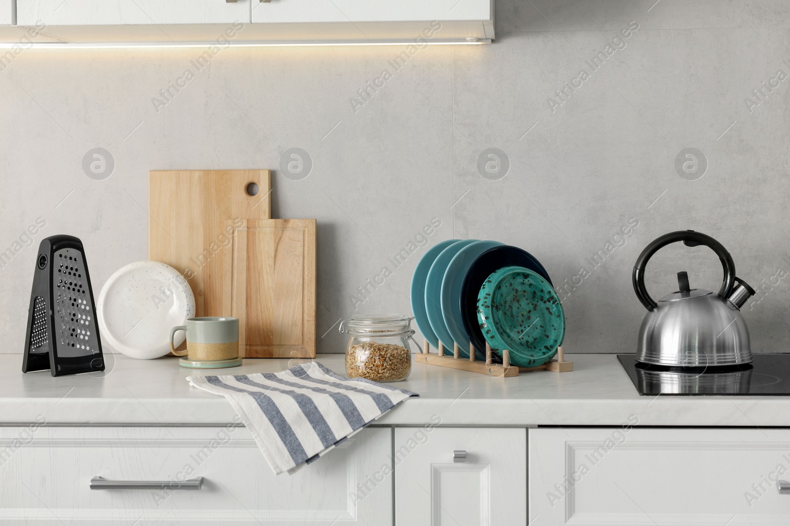 Photo of Set of different utensils and dishes on countertop in kitchen