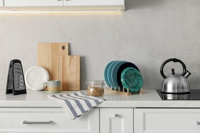 Set of different utensils and dishes on countertop in kitchen