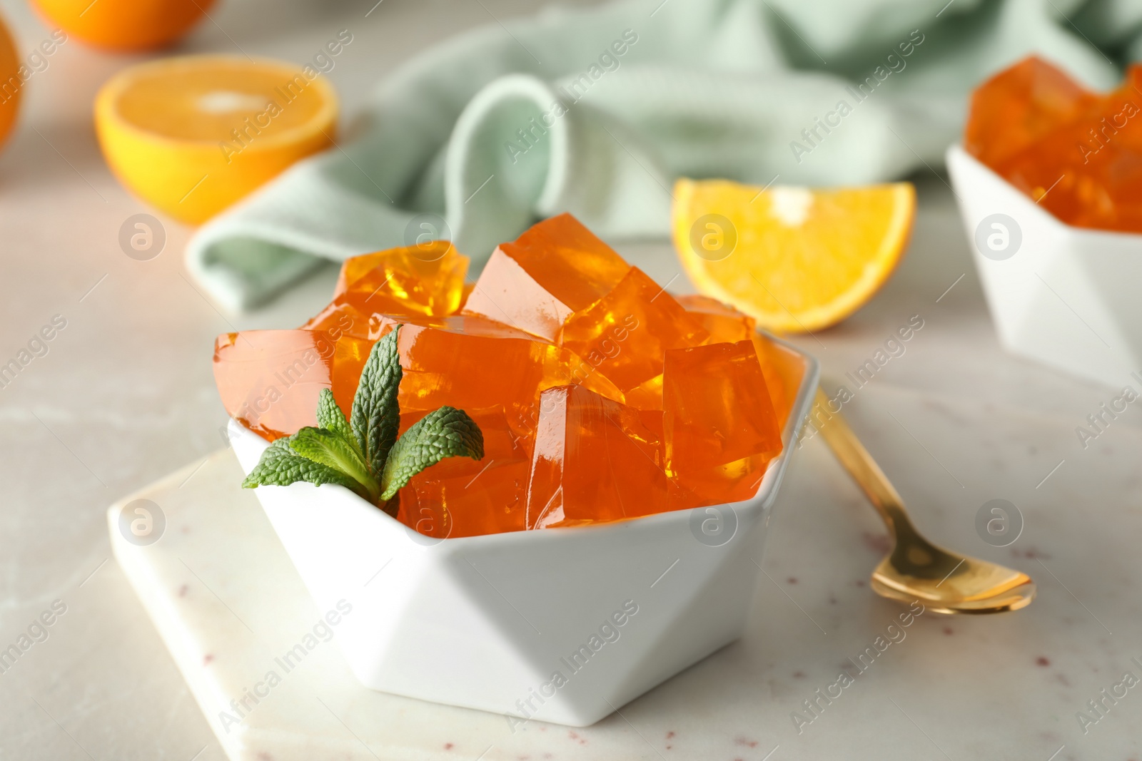 Photo of Orange jelly in bowl on table, closeup