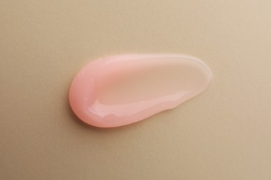 Photo of Sample of cosmetic gel on beige background, top view