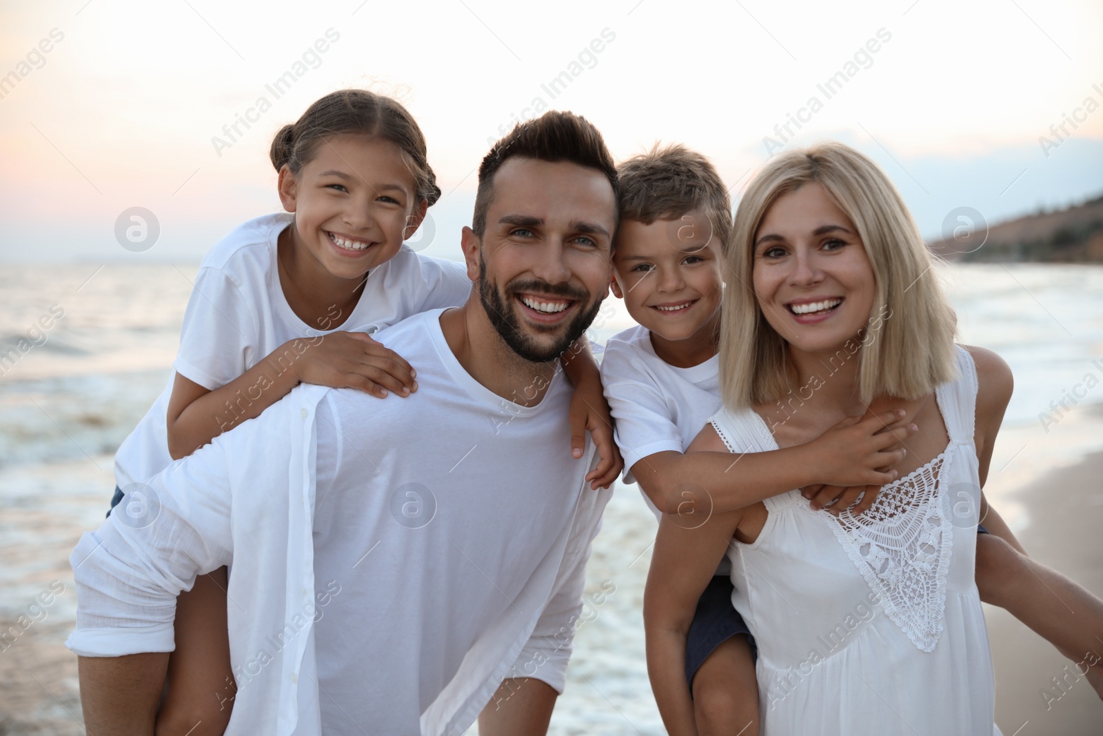 Photo of Happy family on beach near sea. Summer vacation