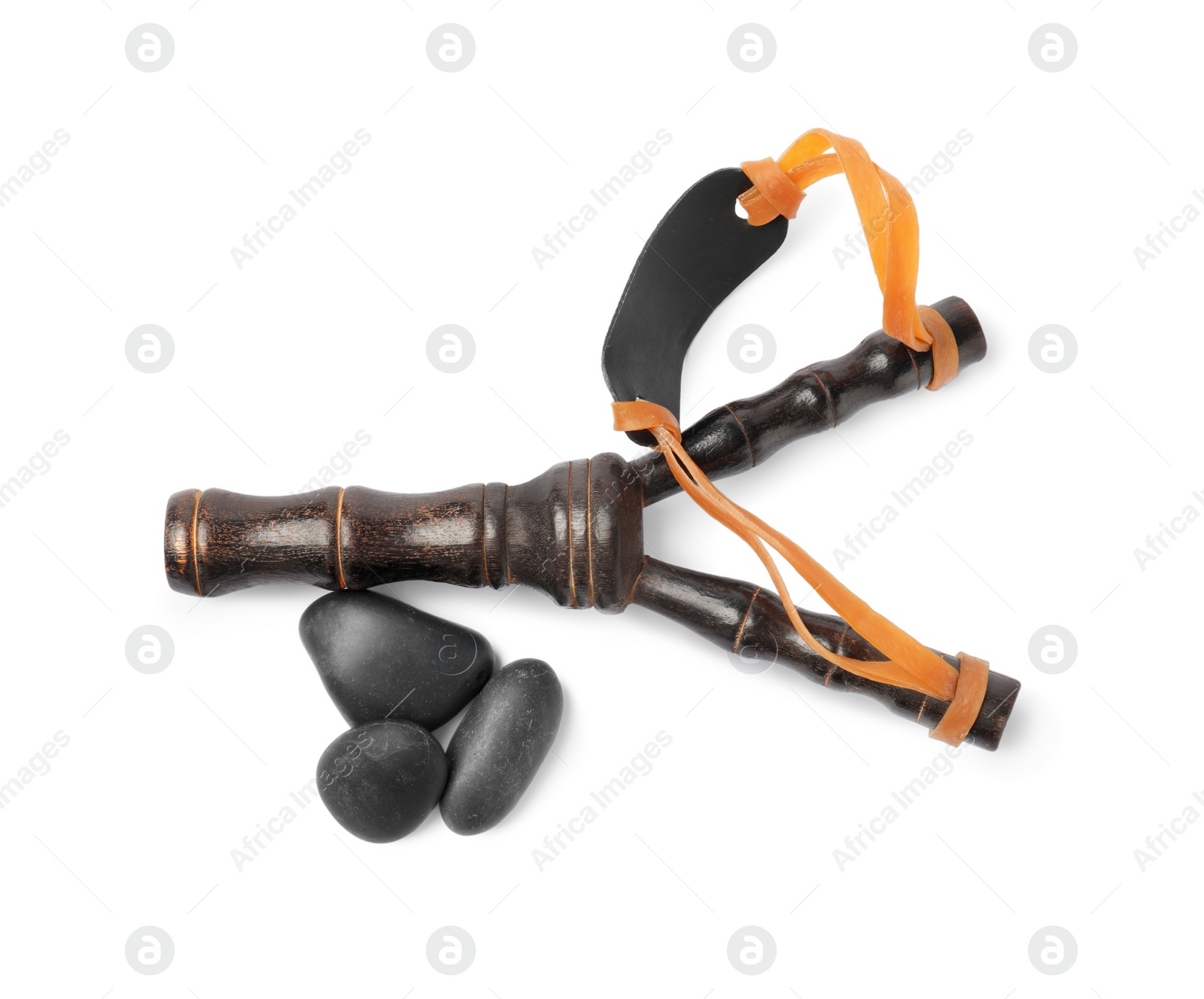 Photo of Black wooden slingshot with stones on white background, top view