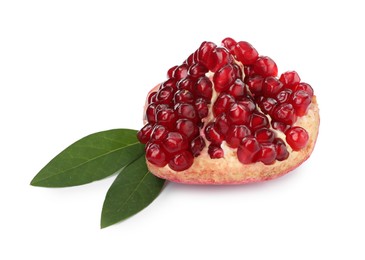 Photo of Piece of ripe juicy pomegranate and green leaves on white background