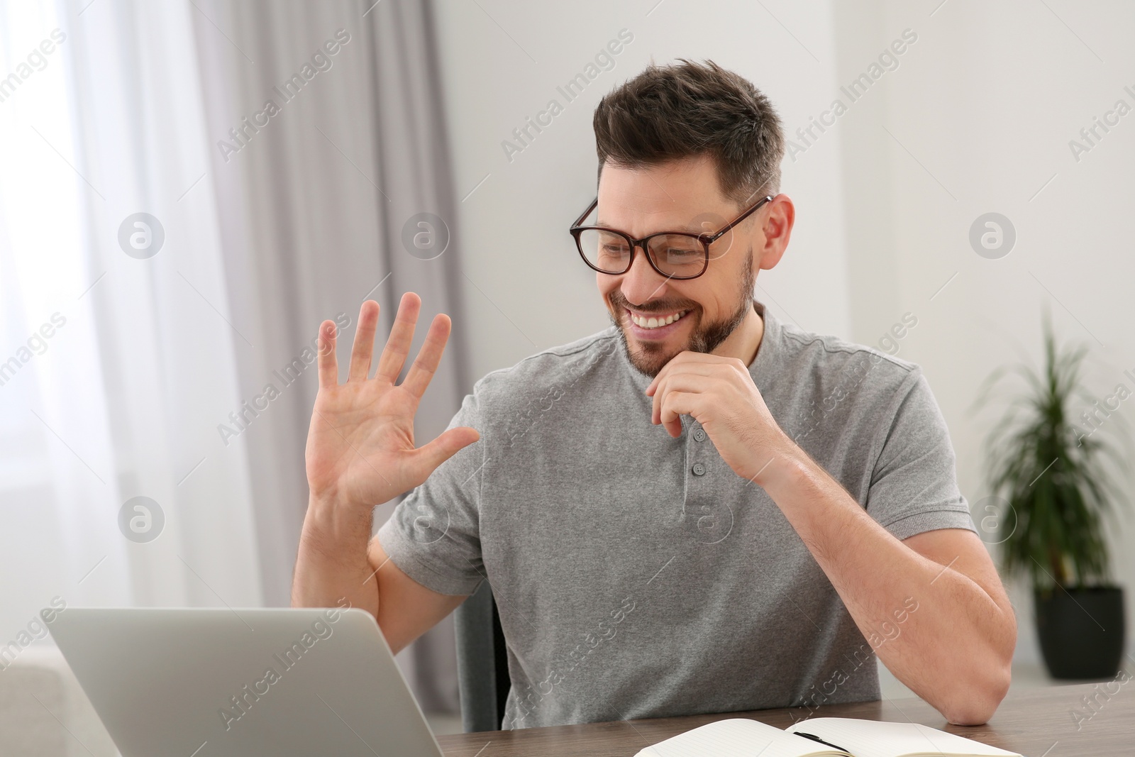 Photo of Man studying on laptop at home. Online translation course