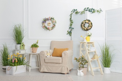 Elegant Easter photo zone with floral decor and armchair indoors