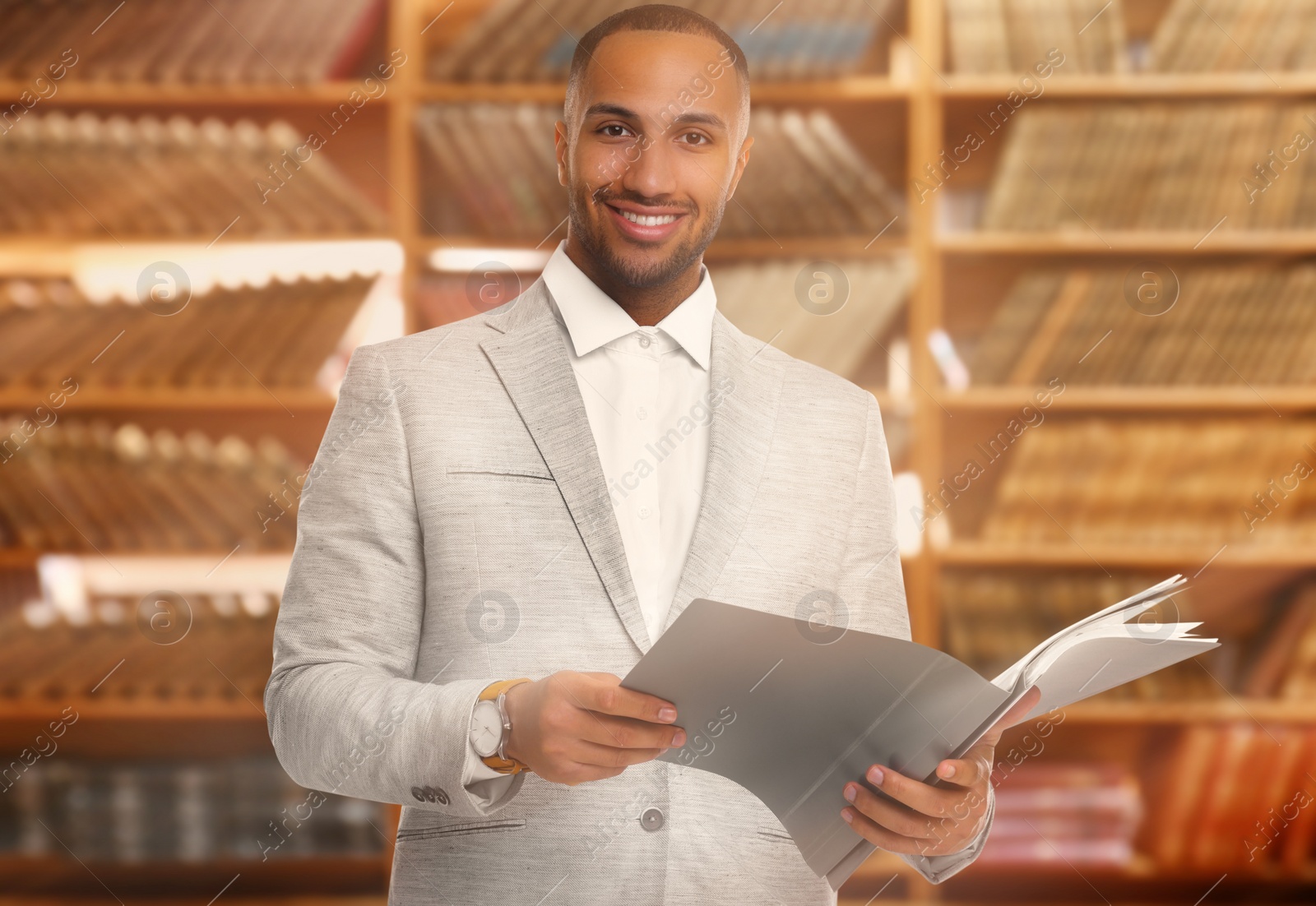 Image of Lawyer, consultant, business owner. Confident man with file folders smiling indoors