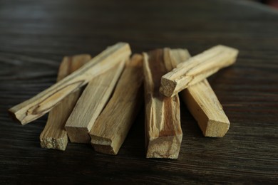 Palo santo sticks on wooden table, closeup