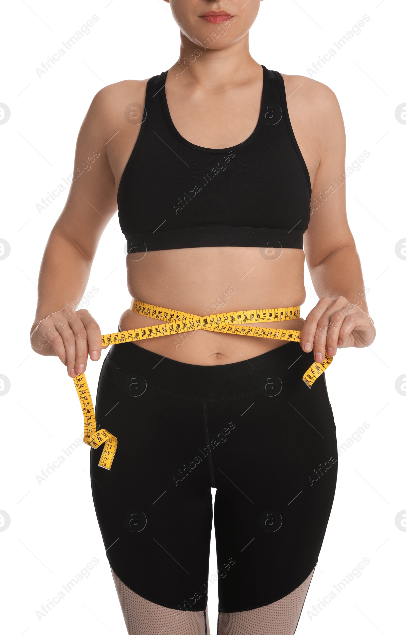 Photo of Woman measuring waist with tape on white background, closeup