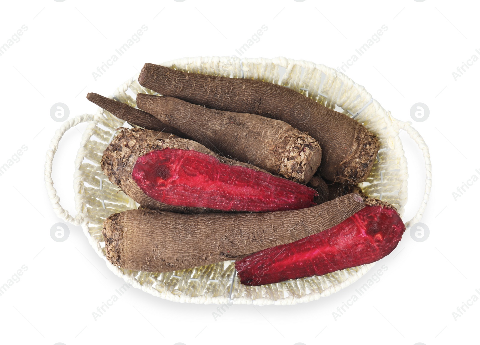 Photo of Whole and cut red beets in basket isolated on white, top view