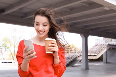 Young woman using mobile phone outdoors