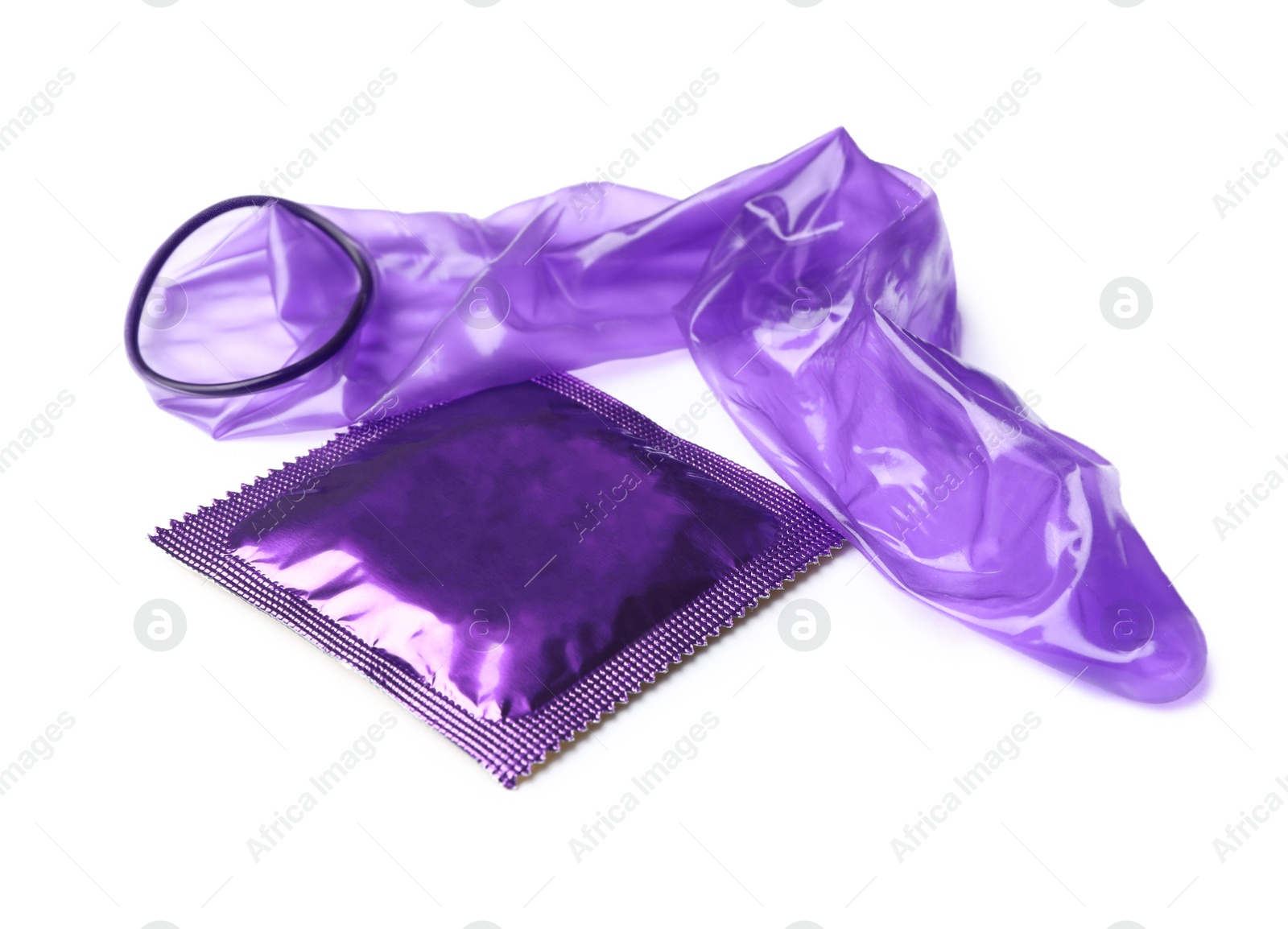 Image of Unrolled violet condom and package on white background. Safe sex