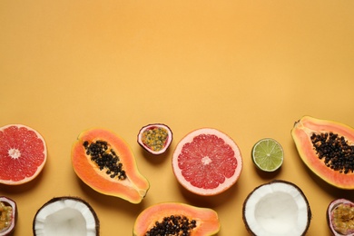 Photo of Fresh ripe papaya and other fruits on yellow background. flat lay. Space for text