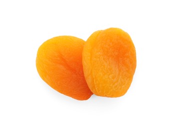 Photo of Two tasty apricots on white background, top view. Dried fruits