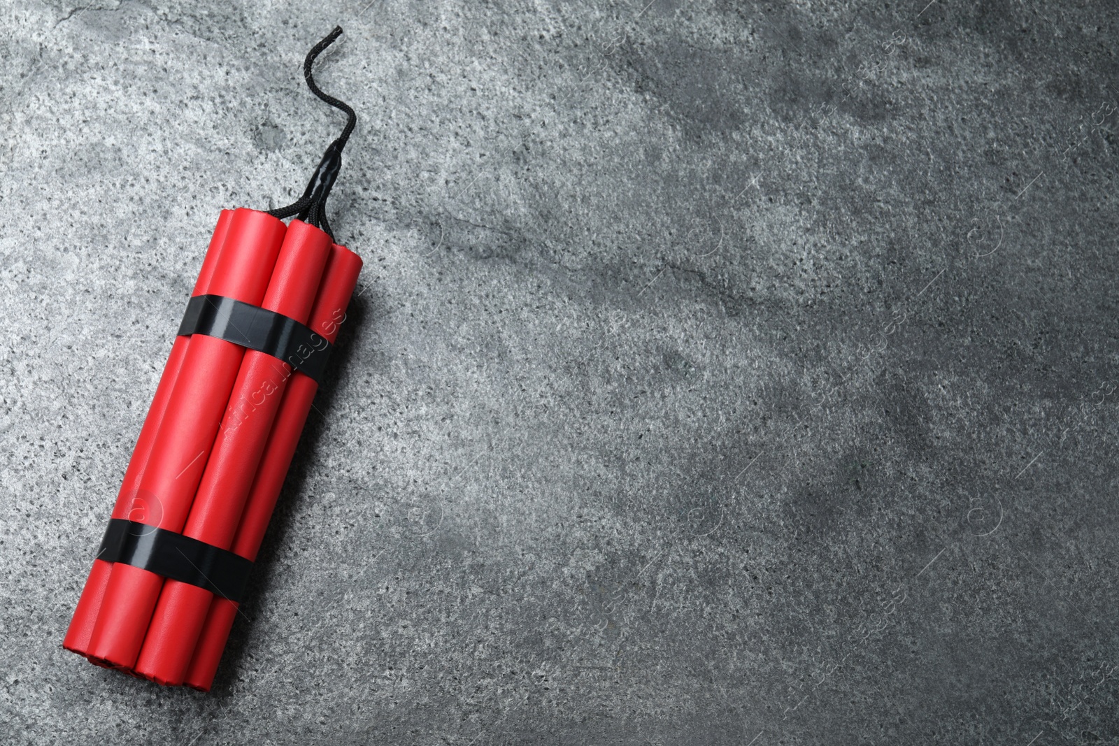 Photo of Dynamite bomb on grey table, top view. Space for text