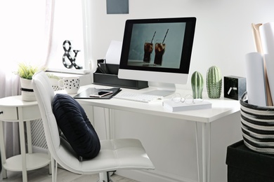 Comfortable workplace with computer on desk in home office